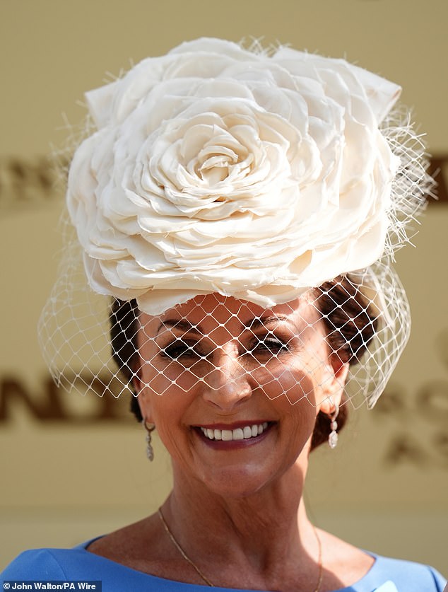 Most striking of all was Shirley's enormous white rose-shaped hat, to which a mesh veil was attached.