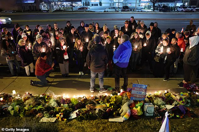 People held a vigil at a makeshift memorial near the Club Q nightclub one night after the horrific shooting.