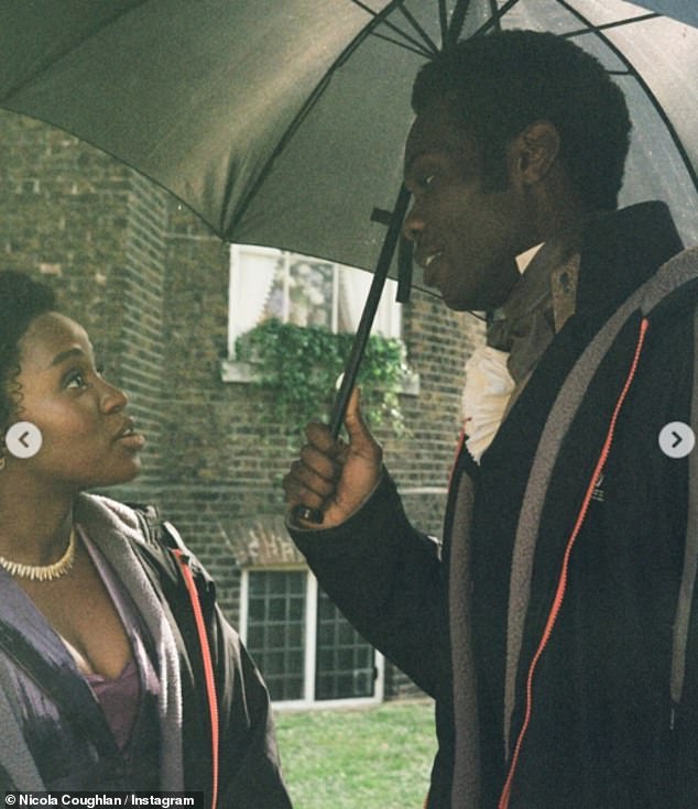 The actors chatted under umbrellas outside the church.