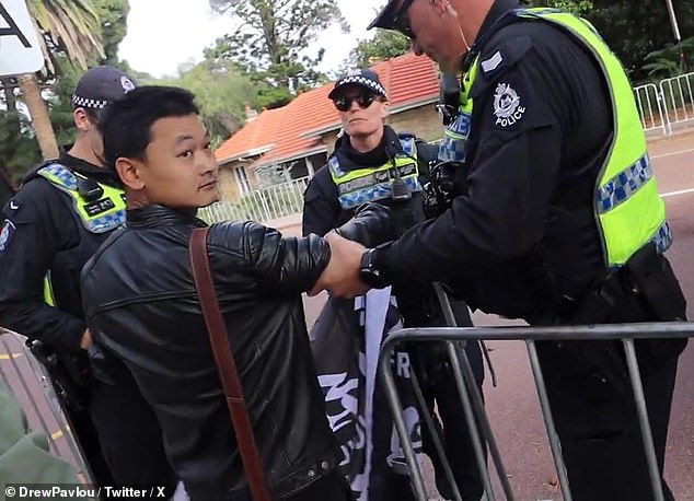 The Tibetan protester was seen being escorted from Kings Park by WA Police officers.