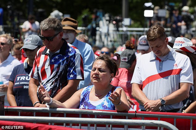 Trump spoke Tuesday, June 18, at a rally in Racine, Wisconsin, just 30 miles south of Milwaukee. In the image: Rally attendees pray before Trump's arrival.