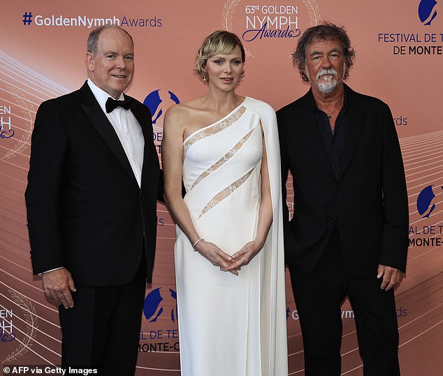 Prince Albert II of Monaco (L), Princess Charlene of Monaco and French actor and director Olivier Marchal (R) pose during the closing ceremony of the 63rd Monte Carlo Television Festival in Monaco.