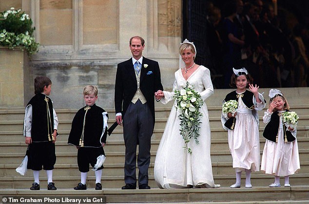 The bride carried a cascading bouquet of ivory roses and white lilies.