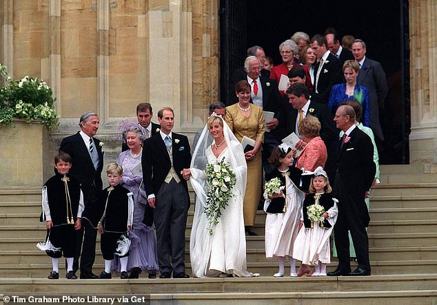 The newlyweds join members of the Royal Family on the steps of St George's Chapel.