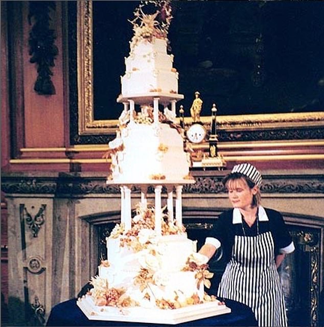 Linda Fripp shows off the ten-foot-tall fondant cake that took her more than 515 hours to make