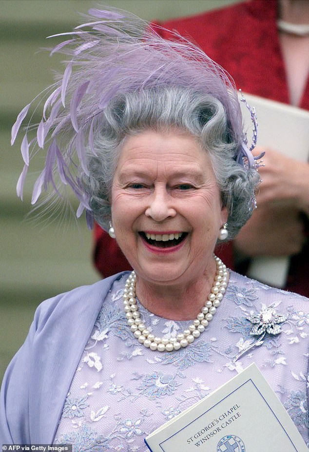 The late Queen Elizabeth wore an embroidered lilac dress and matching feather headdress, even though the couple had advised guests not to wear hats.