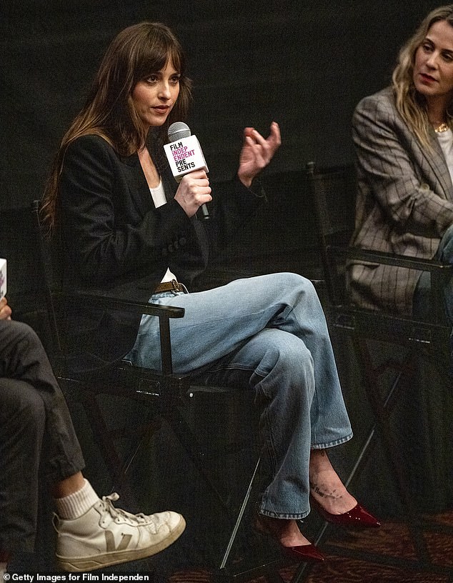 Johnson, who co-produced and starred in the low-budget drama, turned heads in a white tank top and baggy jeans, paired with a stylish oversized jacket and heels.