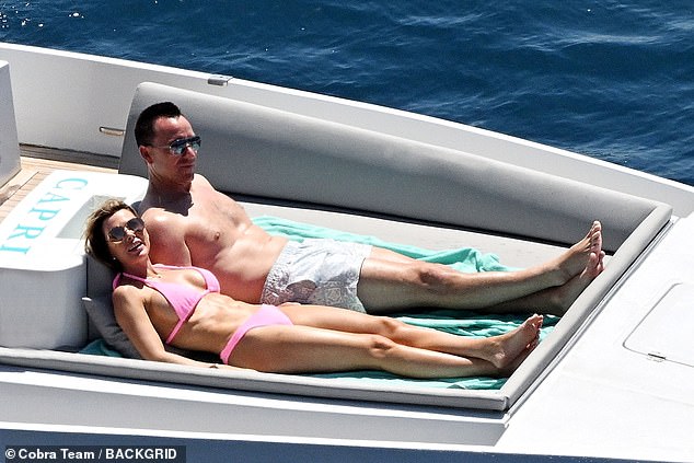 Reclining next to her husband, Toni showed off her slender physique in a powder pink bikini while taking advantage of the high temperatures on the Italian coast.