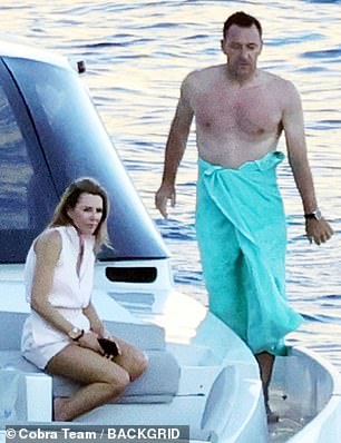 Former Chelsea ace Terry wrapped himself in a beach towel after taking a dip in the ocean.