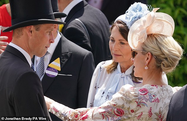 At one point during their conversation, Zara Tindall reached out to adjust the jacket of her cousin, Prince William.