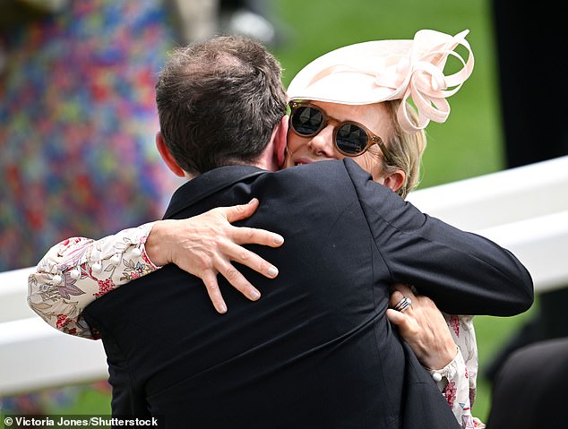 Pictured: Zara Tindall seen hugging her cousin Princess Eugenie's husband Jack Brooksbank at Ascot today.