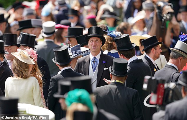 Prince William, attending the society meeting without the Princess of Wales, is seen among the crowd at Ascot Racecourse this afternoon.