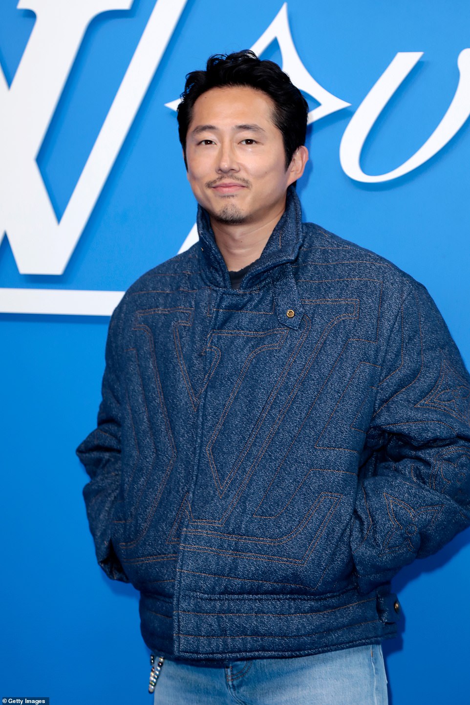 Beef star Steven Yeun looked handsome as he arrived at the star event in a textured denim bomber jacket.