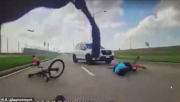 Shocking video showed a white Subaru SUV hitting the back of one cyclist before running over another after knocking him to the ground.