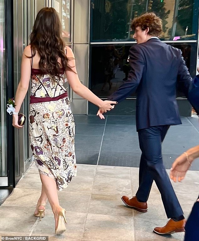 The daughter of Katie Holmes and Tom Cruise was seen holding hands with handsome young singer Toby Cohen while heading to her high school dance in New York on Wednesday.