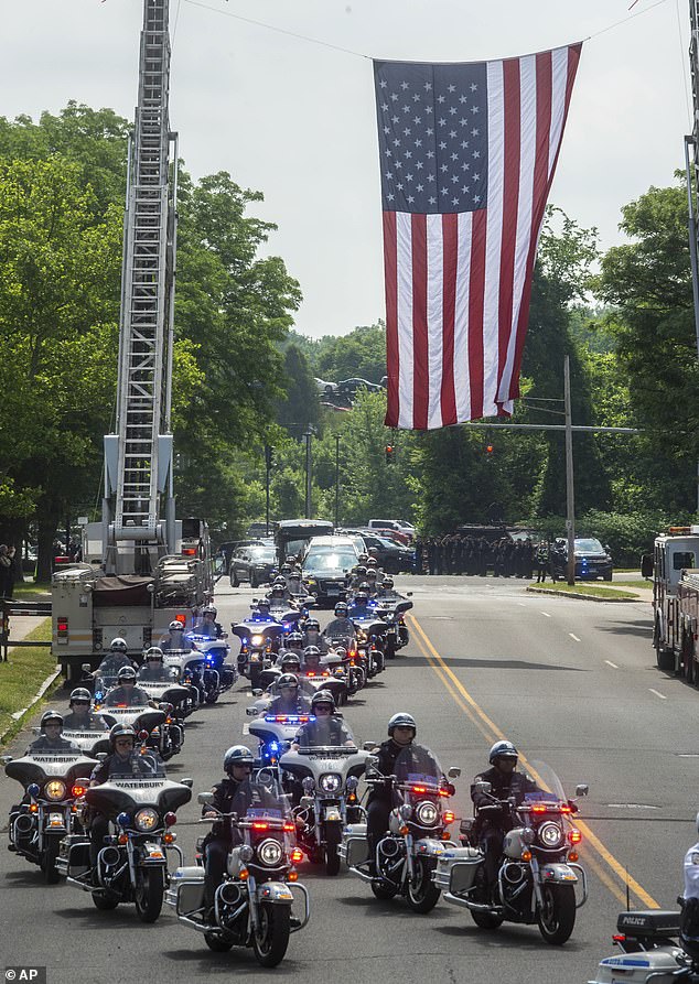 Motorcycles from state and local law enforcement agencies escort Connecticut State Trooper Aaron Pelletier to the Xfinity Theater for his funeral in Hartford, Connecticut.