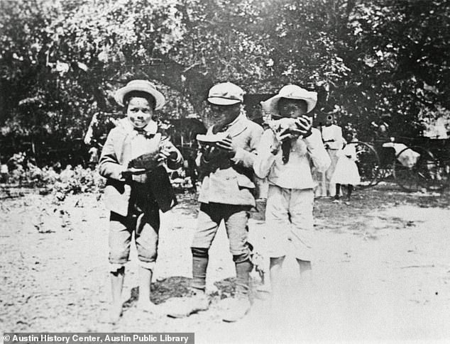 Group portrait of three young African Americans at the Emancipation Day celebration, June 19, 1900.