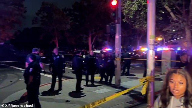 At least four people were taken to the hospital with gunshot wounds following the incident at Lake Merrit on Wednesday night shortly before 9 p.m. In the image: Dozens of police place a cordon around the place.