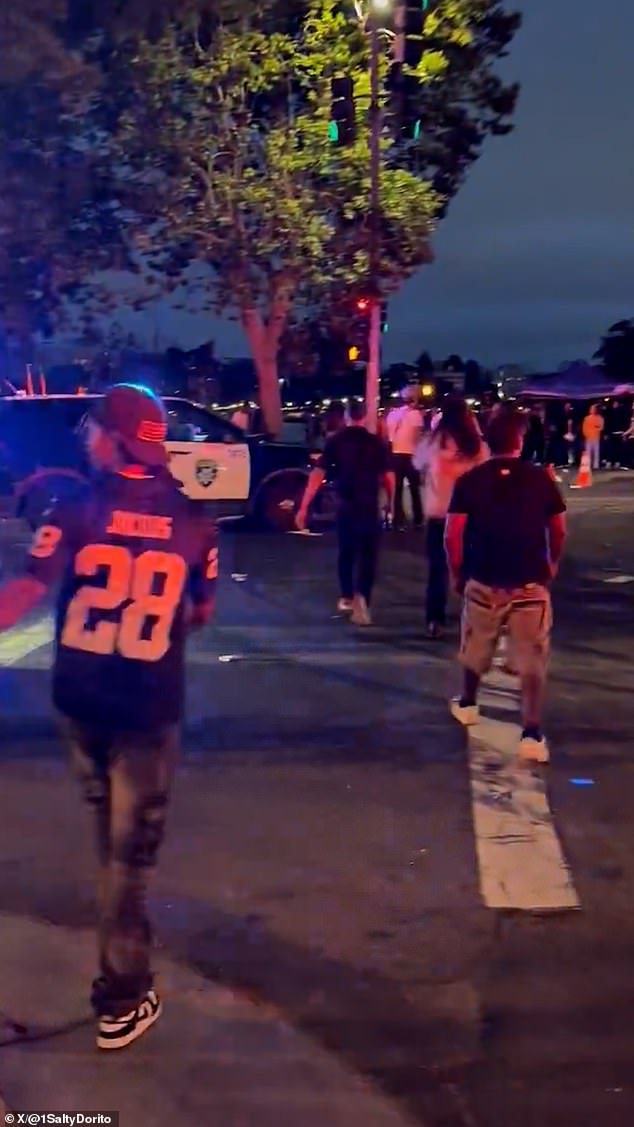 A video posted on social media shows a crowd of thousands of people dispersing and fleeing the scene amid gunfire.