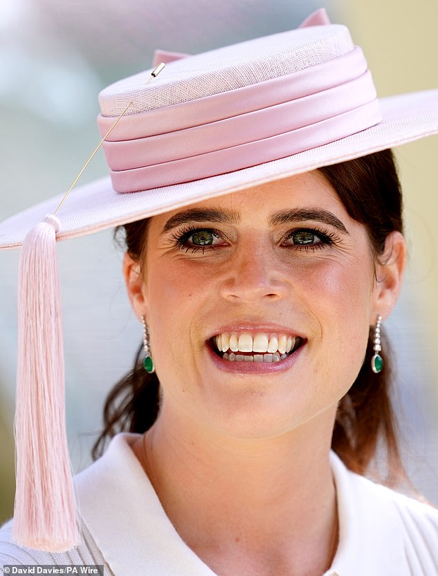 Eugenie wore summery makeup, combining peach blush with thick eyelashes and glossy lips.