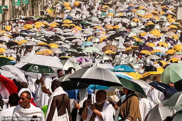 Muslim pilgrims use umbrellas to protect themselves from the sun as they arrive at the base of Mount Arafat, also known as Jabal al-Rahma or Mount of Mercy, during the hajj pilgrimage.