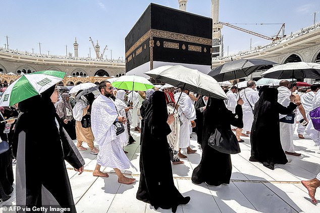 Muslim devotees walk around the Kaaba, Islam's holiest shrine, at the Grand Mosque in the holy city of Mecca in Saudi Arabia on June 13, 2024.