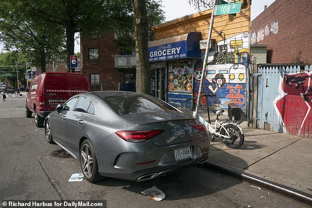 The suspect managed to crawl to safety under this silver Mercedes, and that act likely saved his life.