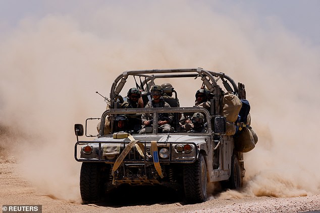 A military vehicle maneuvers near the border between Israel and Gaza, amid the conflict between Israel and Hamas, as seen from Israel, on June 20, 2024.