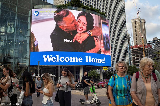 A screen shows an image of Noa Argamani, who was kidnapped during the deadly Oct. 7 attack and has since returned home.