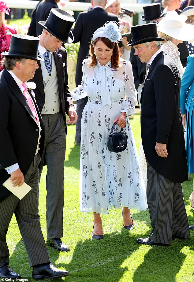 Carole clings to Prince William for support as she chats to him and her husband Michael at Royal Ascot yesterday.