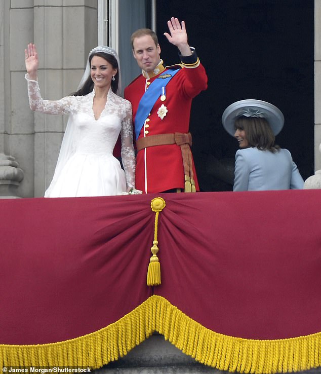 Kate and Prince William wave to the crowds from the balcony of Buckingham Palace on their wedding day, as Carole Middleton smiles alongside them.