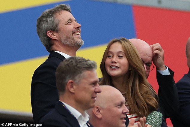 The teenager enjoyed the game while watching with her father.