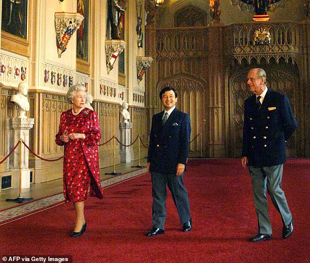 Naruhito walks through Windsor Castle with Queen Elizabeth and Prince Philip in 2001