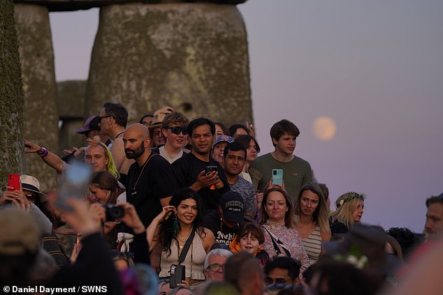 Midsummer celebration at Stonehenge as the sun sets