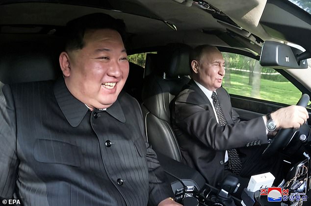 Russian President Vladimir Putin drives North Korean leader Kim Jong Un in an Aurus limousine in Pyongyang, North Korea, June 19, 2024.