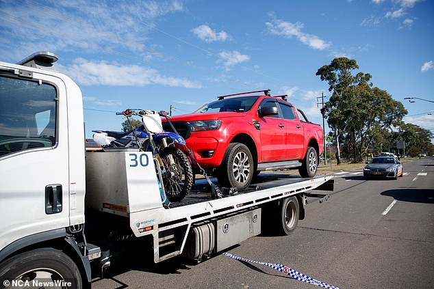 The alleged victim's red Ford Ranger is pictured being towed from the scene Thursday.