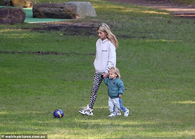 The couple dressed casual and tough as they played in a park in the Sydney suburb of Vaucluse, with their mother Tegan wearing a white Barcelona hoodie.