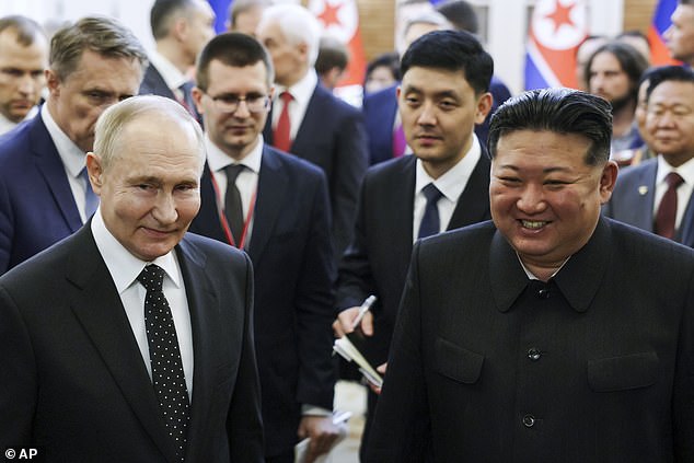 Russian President Vladimir Putin, left, and North Korean leader Kim Jong Un smile as they walk after talks in Pyongyang, North Korea, Wednesday, June 19, 2024.