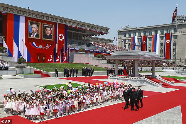 Russian President Vladimir Putin, left, and North Korean leader Kim Jong Un, right foreground, attend the official welcoming ceremony at Kim Il Sung Square in Pyongyang, North Korea, Wednesday 19 June 2024.