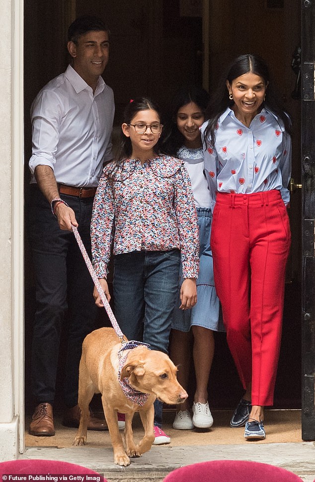 Prime Minister Rishi Sunak and his wife Akshata Murty are joined by their daughters Krishna and Anoushka and their dog Nova as they host a grand coronation lunch outside Downing Street on May 7, 2023.