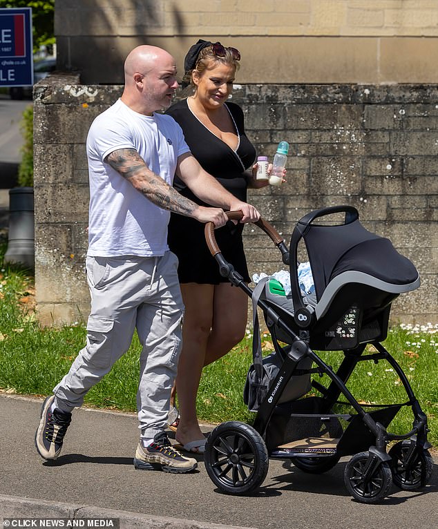 The actress, 37, looked great in a black wrap mini dress as she strolled with her boyfriend Anthony Huggins and their new bundle of joy on their way to register the baby's birth.