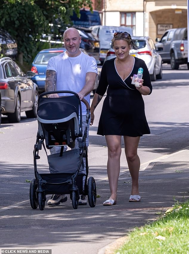 The happy couple couldn't keep the smile off their faces as they stepped out with their little one.