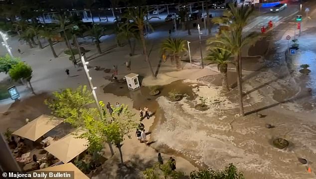 In video of the moment the water falls on the road, people can be seen walking alongside the alarming flood.