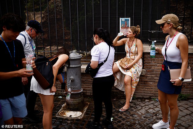 A woman fills her bottle with water at a fountain near the Colosseum amid a heat wave in Rome, Italy, on June 20, 2024.