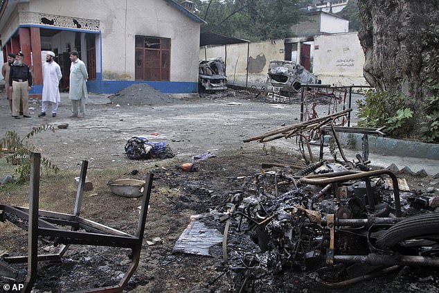 Burned debris is seen throughout the area where hundreds of people took part in a violent attack.