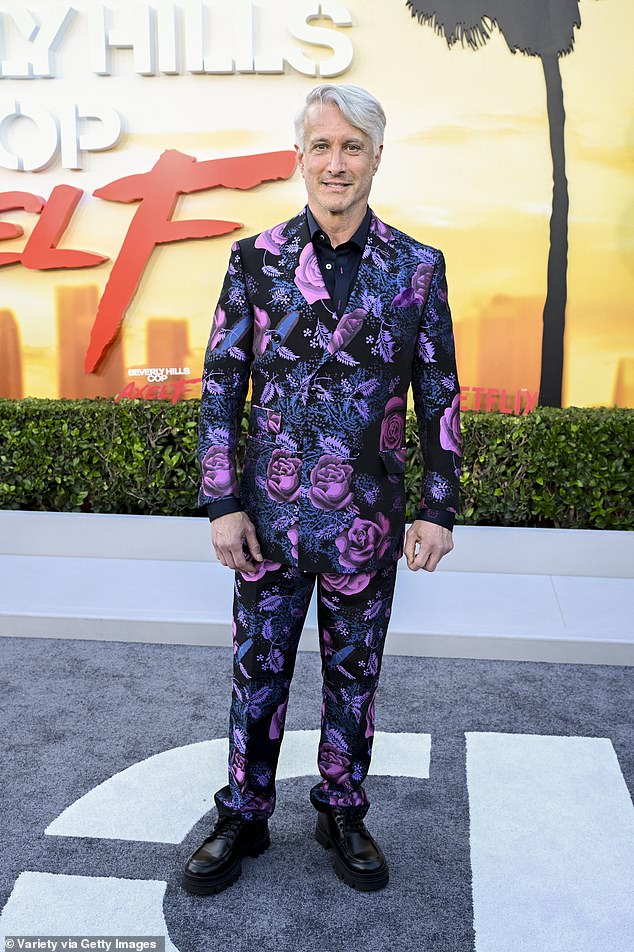 Always one of a kind, Bronson Pinchot, 65, stood out in a purple and black floral suit with matching shoes and dyed platinum blonde hair parted on the right side.