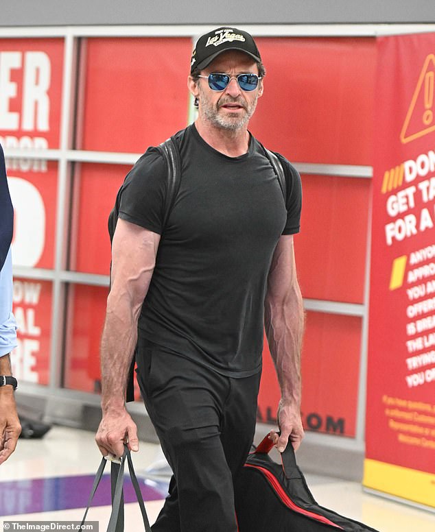 The Wolverine star looked incredible in a tight-fitting T-shirt that showed off his sculpted pecs and massive biceps. (In the photo)