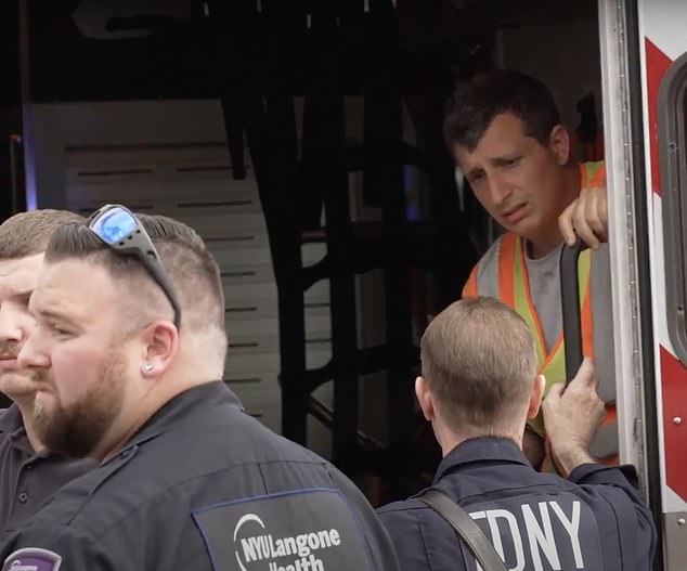 The driver of the truck that hit Conigliaro was comforted in an FDNY ambulance.