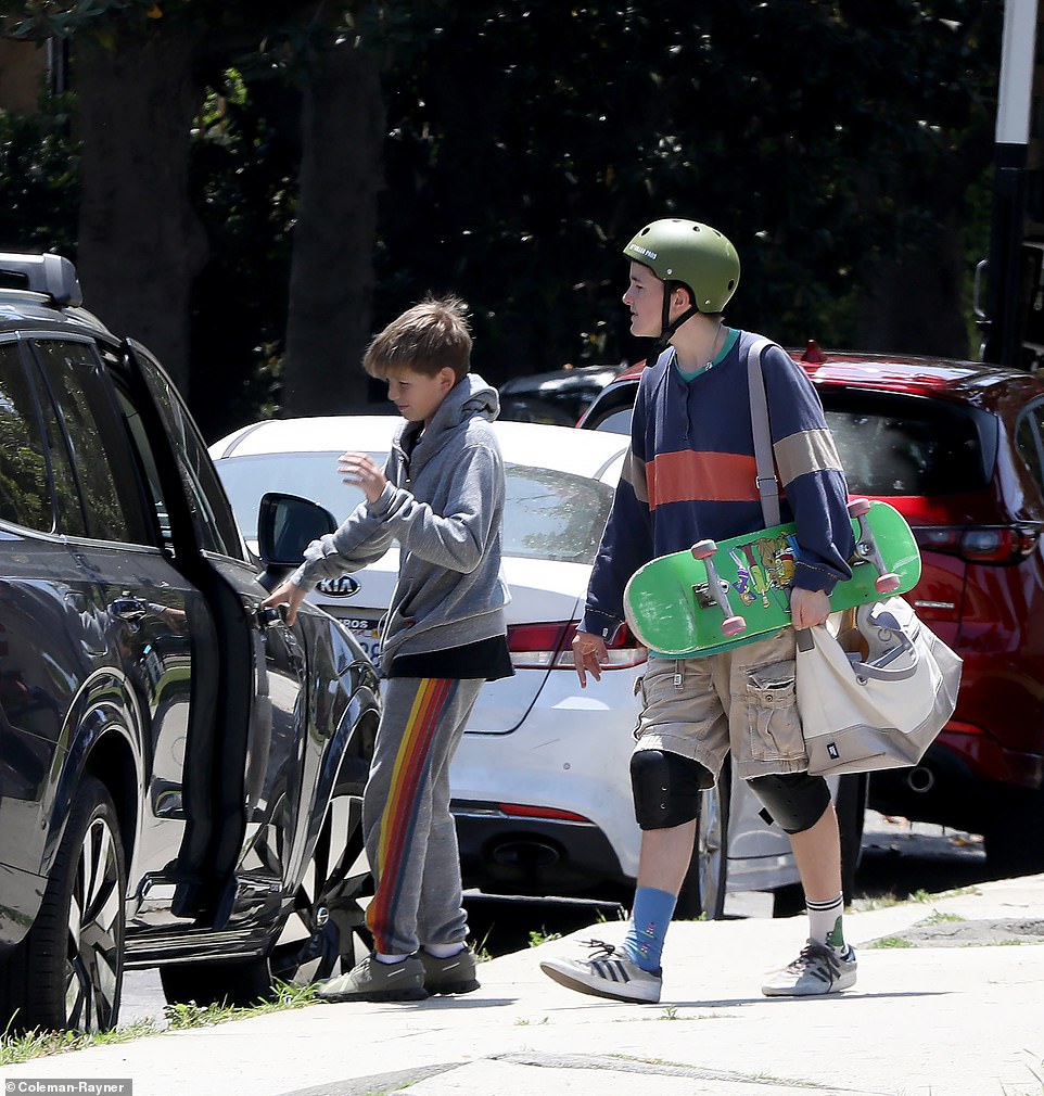 Samuel wore a gray tracksuit with a rainbow stripe on the side as the youngsters piled into the car after burning off some energy at the skatepark.