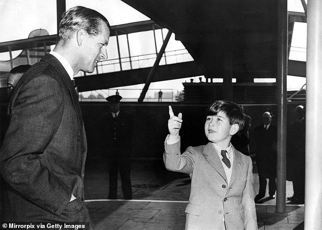 Prince Philip seen with his son, Prince Charles, in 1956 as he prepared to leave for his Commonwealth tour.